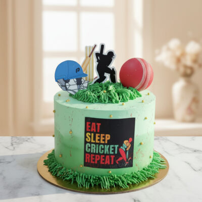 Cricket theme cake with green frosting, cricket bats, and ball toppers