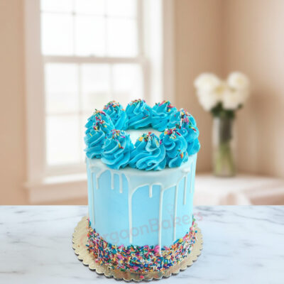 A beautiful blue cake with swirls of frosting and colorful sprinkles from Gurgaon Bakers