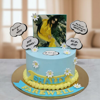 A beautifully designed farewell cake with blue frosting and floral decorations.