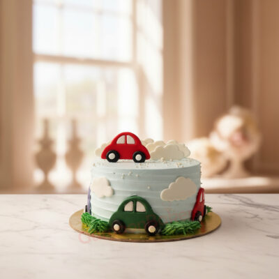A beautifully crafted first birthday car cake with cars made of fondant and soft clouds