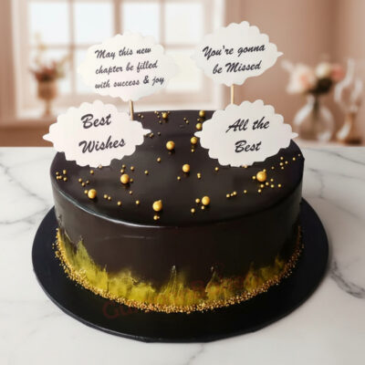 A beautifully designed farewell cake with golden decorations and heartfelt messages.