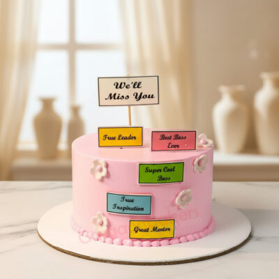 Pink farewell cake with colorful message plaques