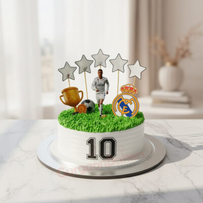 Ranaldo themed sports cake featuring grass, cup, and football decorations.