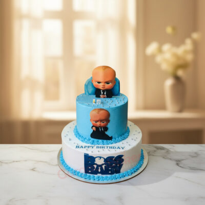 Tier Boss Baby Cake design featuring a seated Boss Baby and vibrant blue frosting.