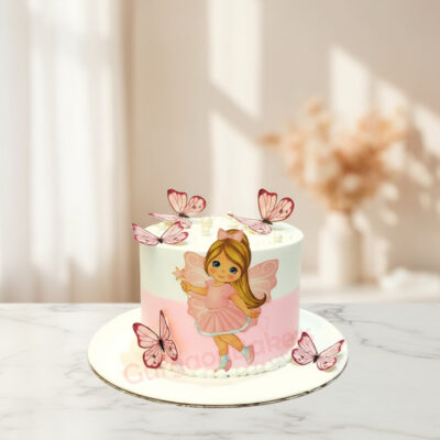 A whimsical butterfly themed cake with a fairy and decorative butterflies