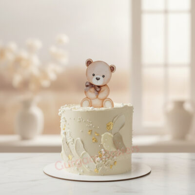 Whimsical teddy bear kids birthday cake decorated with edible gold and delicate frosting.