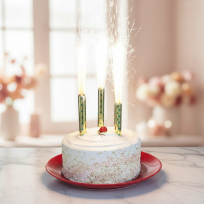 A beautiful cake without cream adorned with decorative sprinkles and sparklers.