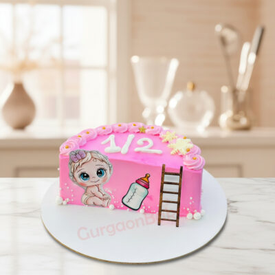 Half birthday cake with baby design and pink frosting