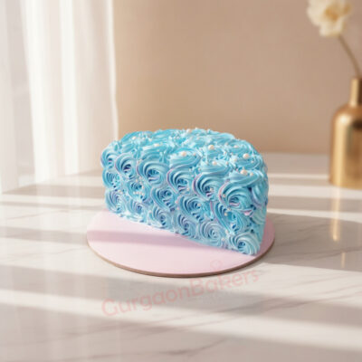 A beautiful blue half birthday cake decorated with swirls and pearls.