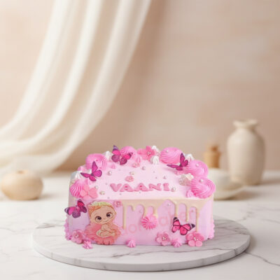 A whimsical half birthday cake for a girl, decorated with butterflies and flowers.