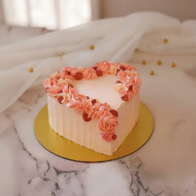 Heart-shaped Valentine's cake decorated with pink and rose flowers