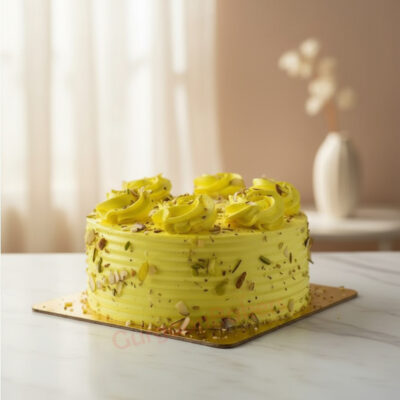 Custom rasmalai cake decorated with yellow frosting and nuts
