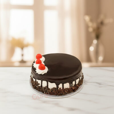 A delicious healthy chocolate cake topped with cherries and cream.