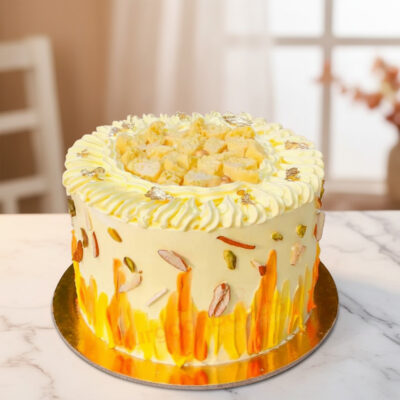 Delicious rasmalai cake beautifully decorated with nuts and cream.