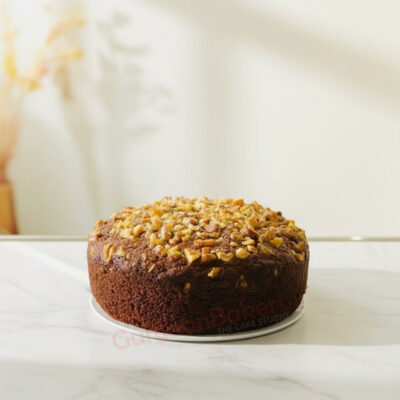 A healthy sugar-free cake topped with nuts.