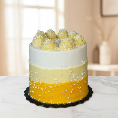 A beautifully crafted sugar free cake with white and yellow layers, topped with cream swirls and decorative sprinkles.
