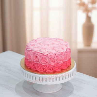 A beautiful pink smash cake decorated with rosettes for birthday celebrations