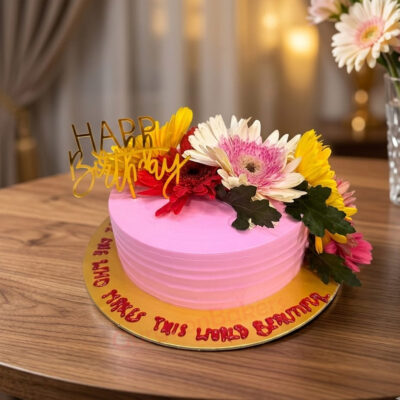A beautifully decorated pink flower anniversary cake with fresh flowers in Gurgaon | Gurgaon Bakers