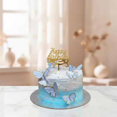 Beautiful Butterfly Birthday Cake adorned with butterflies and a golden Happy Birthday topper.
