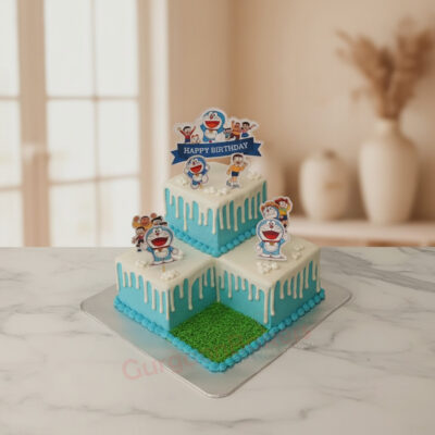 Doraemon themed cake with blue and white icing, featuring character toppers in Gurgaon | Gurgaon Bakers