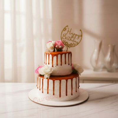 Elegant 2 tier birthday cake with floral decorations and caramel drizzle in Gurgaon | Gurgaon Bakers