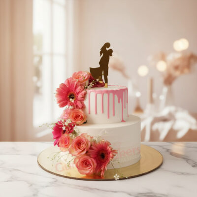 Two-tier engagement cake with pink drips and floral decorations in Gurgaon | Gurgaon Bakers