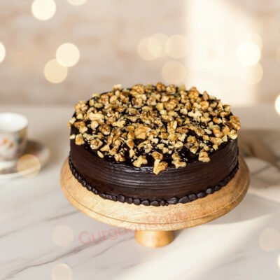 Healthy Nutty Cake topped with walnuts and chocolate frosting