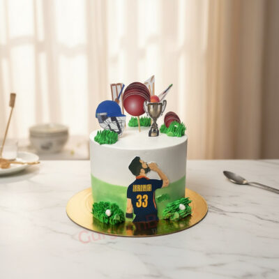 A vibrant Virat Kohli cricket-themed cake topped with decorations like a trophy, cricket balls, and a player figurine.