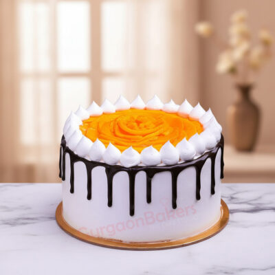 Choco Mango Cake decorated with white icing and mango topping in Gurgaon | Gurgaon Bakers