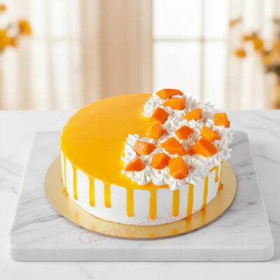 A beautifully decorated mango cake topped with fresh mango chunks and whipped cream in Gurgaon | Gurgaon Bakers