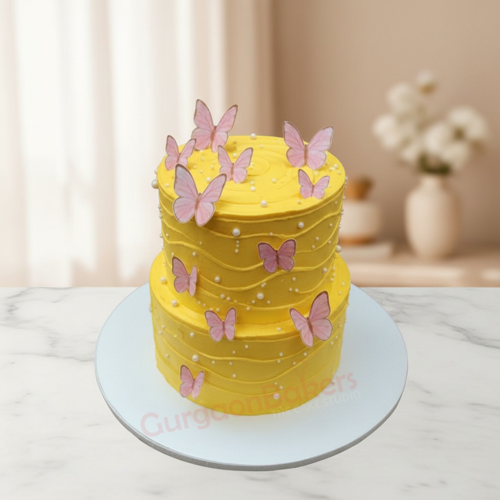 Mango Butterfly Birthday Cake Twotier mango birthday cake decorated with pink butterflies and white pearls in Gurgaon | Gurgaon Bakers