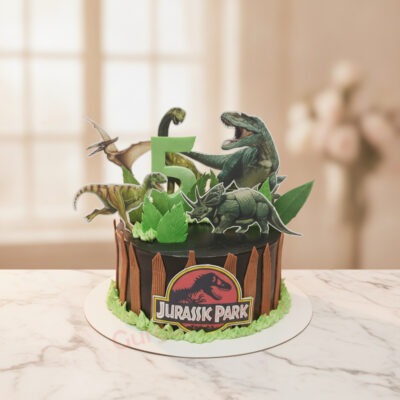 Cute dino cake with Jurassic Park theme and dinosaur toppers in Gurgaon | Gurgaon Bakers