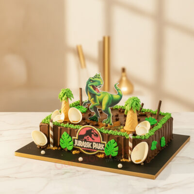 A vibrant dinosaur birthday party cake featuring a T-Rex, colorful decorations, and dino eggs in Gurgaon | Gurgaon Baker