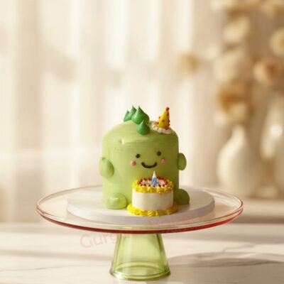 A bright green dinosaur theme cake with a smiling face and a small cake on top in Gurgaon | Gurgaon Bakers