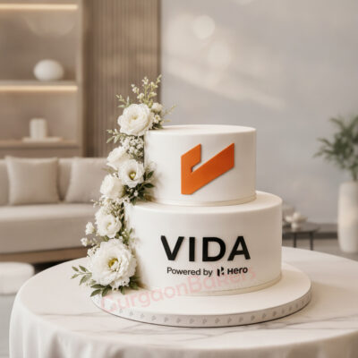 Custom office promotion cake decorated with white flowers and corporate logo in Gurgaon | Gurgaon Bakers
