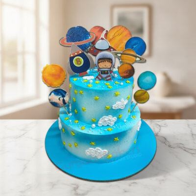 Colorful two-tiered space birthday cake with planets and an astronaut in Gurgaon | Gurgaon Bakers